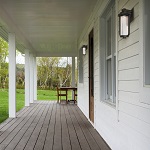 Long wooden porch of a modern farmhouse. Outdoors photography.